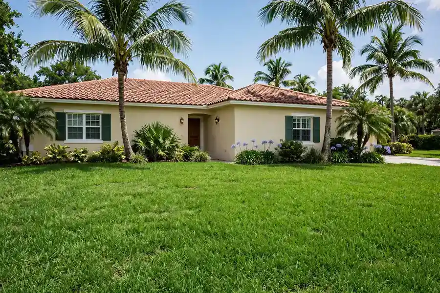 Thick St. Augustine lawn in front of a Florida home in summer