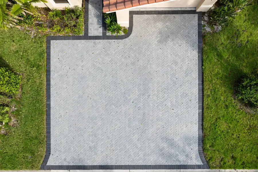 Two-car herringbone paver driveway with a contrasting border